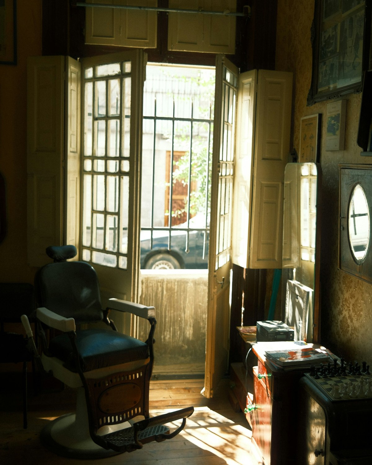 The shop door propped open onto the street, sunlight across the floor